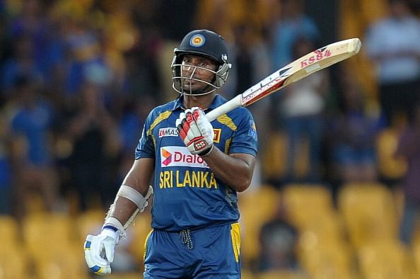 Sri Lankan batsman Kumar Sangakkara raises his bat after he scored 150 runs during the first One Day International (ODI) match between Sri Lanka and South Africa at the R. Premadasa Stadium in Colombo on July 20, 2013. (Getty Images)